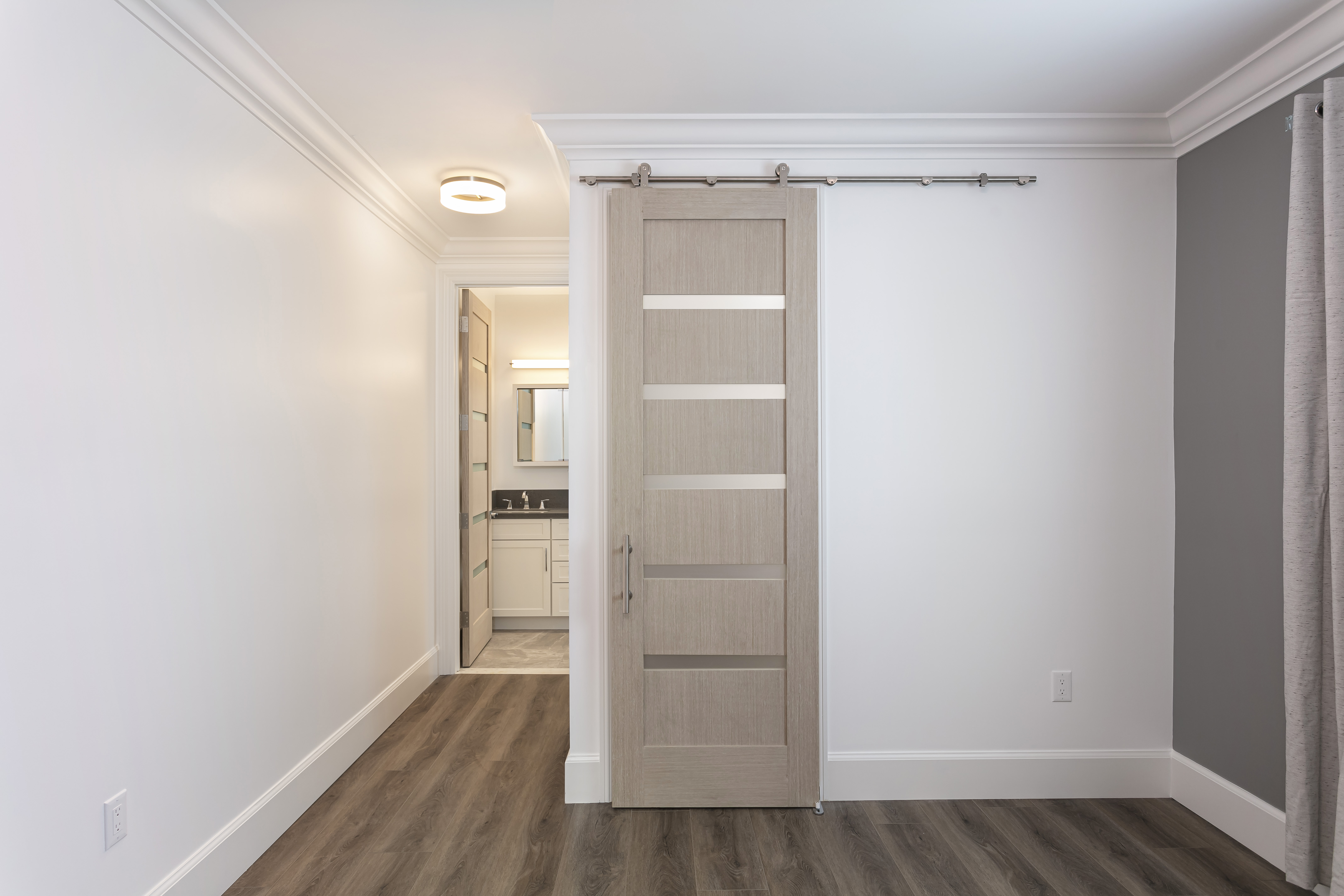 ADU bedroom with sliding barn door and ensuite
