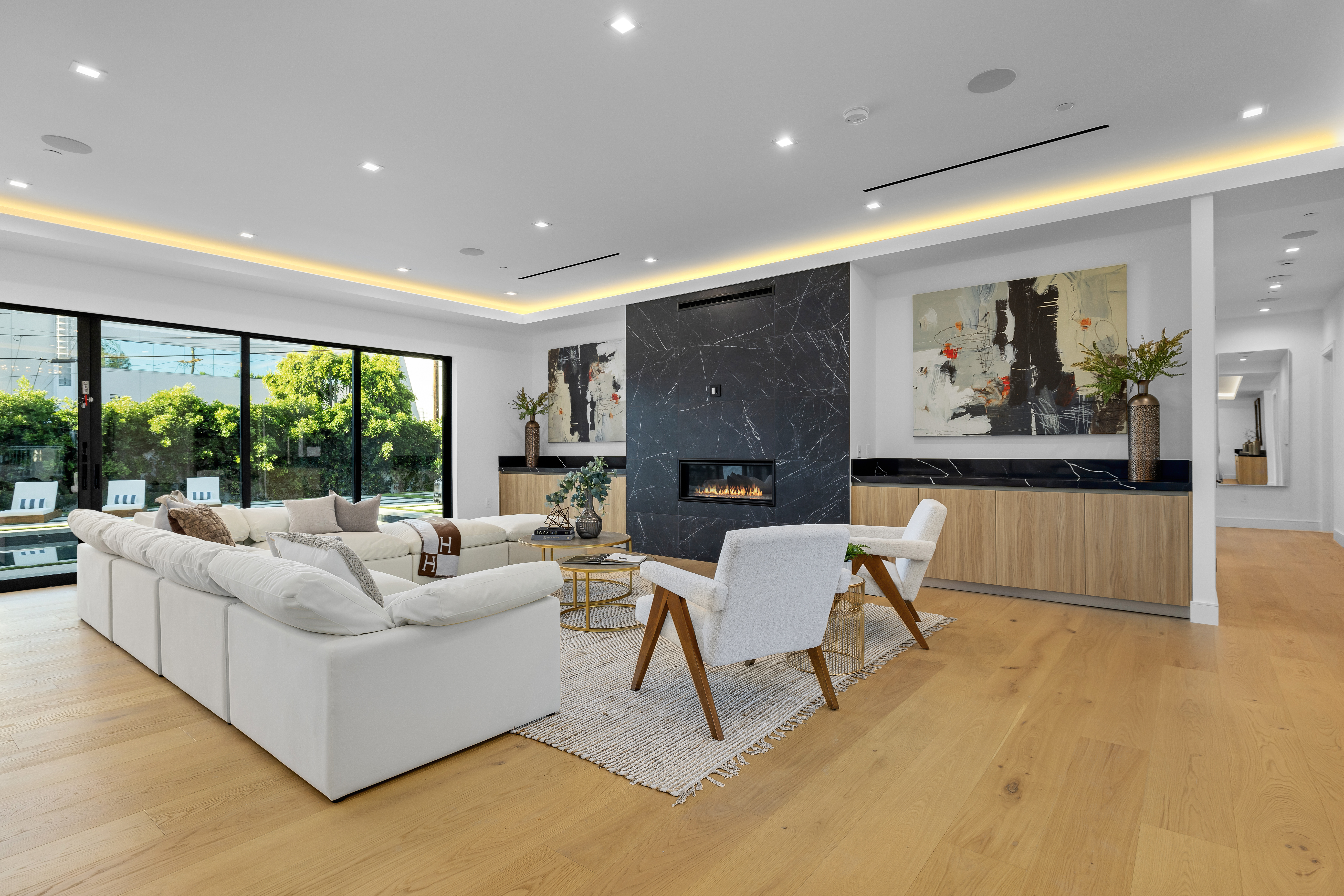 Great room with linear fireplace and oak floors — DWD Builders Encino